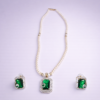White pearl beaded statement necklace set with green crystal pendant and matching earrings by Elysian Elite