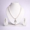 Silver-tone freshwater pearl necklace set with ornate pearl drop pendant and matching dangle earrings on white bust display