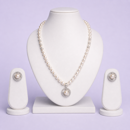 Silver-tone freshwater pearl necklace set with circular halo pendant and matching pearl stud earrings on white bust display