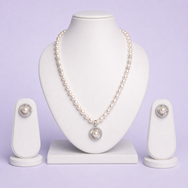 Silver-tone freshwater pearl necklace set with circular halo pendant and matching pearl stud earrings on white bust display