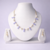 Gold-tone lavender chalcedony bar and freshwater pearl necklace set with matching pearl drop earrings on white bust display