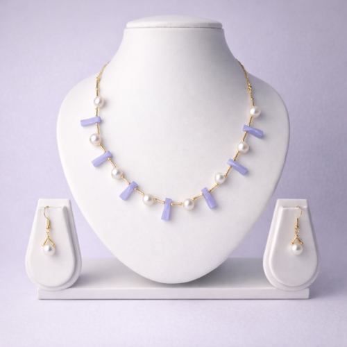 Gold-tone lavender chalcedony bar and freshwater pearl necklace set with matching pearl drop earrings on white bust display